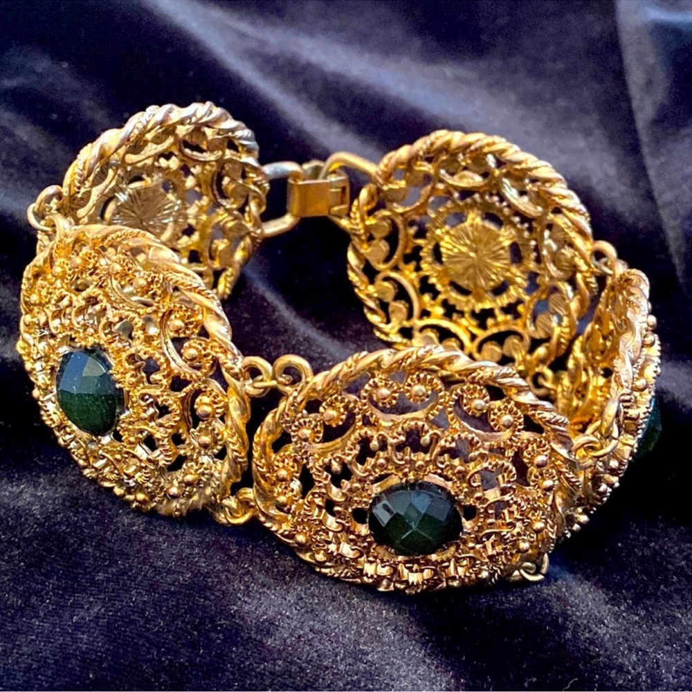 Golden bracelet with green gems